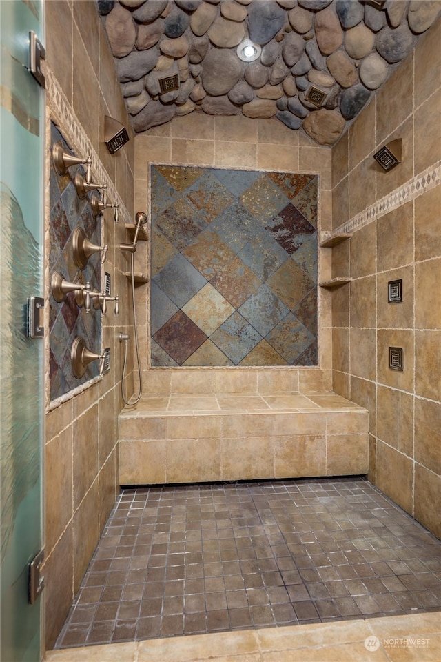 bathroom with tiled shower