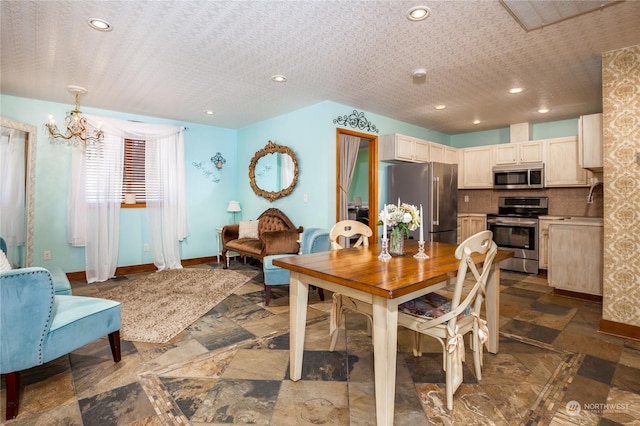 dining space with a notable chandelier and a textured ceiling