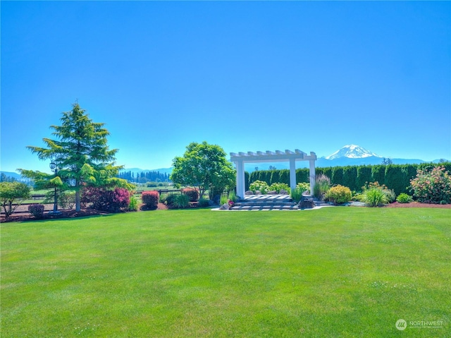 view of yard with a mountain view and a pergola