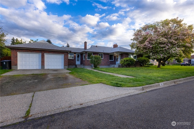 single story home featuring a garage and a front lawn