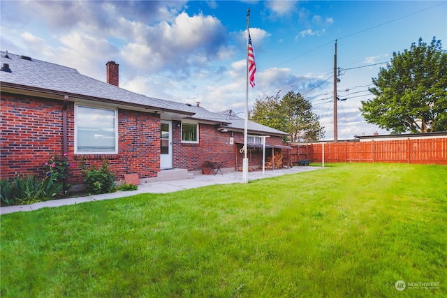 rear view of house featuring a yard