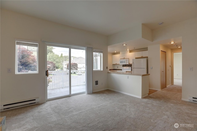 unfurnished living room featuring a baseboard radiator and light carpet