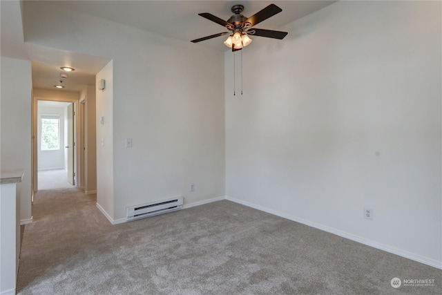 carpeted empty room with baseboard heating and ceiling fan