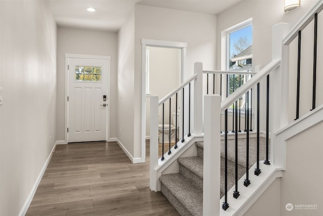 entryway with a wealth of natural light and light hardwood / wood-style flooring