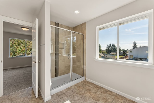 bathroom with a shower with shower door