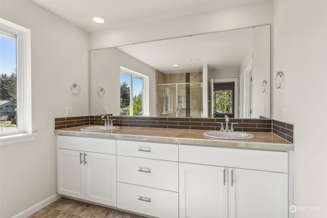 bathroom featuring vanity and a shower with shower door