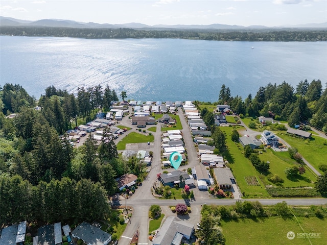 birds eye view of property with a water and mountain view