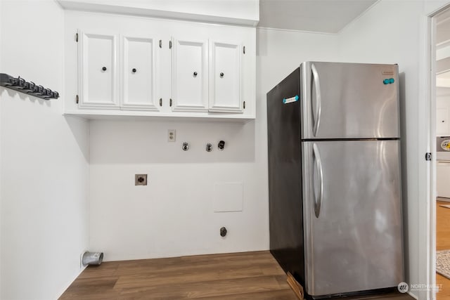 laundry room featuring wood-type flooring, cabinets, and electric dryer hookup