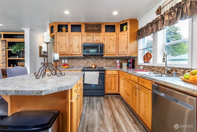 kitchen featuring dishwasher, backsplash, range with electric stovetop, crown molding, and sink