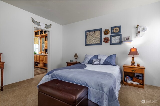 carpeted bedroom featuring ensuite bath