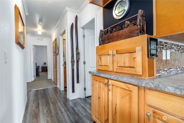 hall with dark hardwood / wood-style flooring and ornamental molding