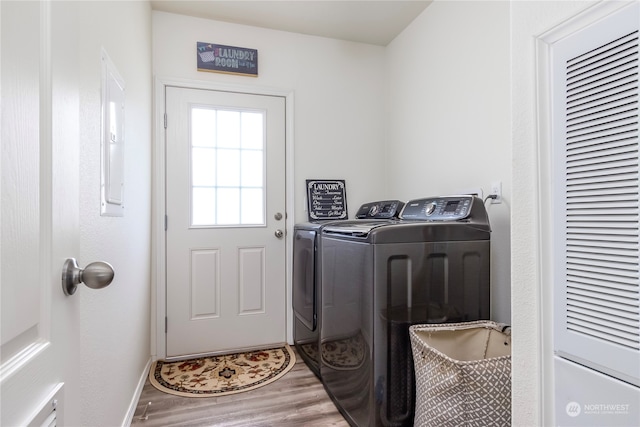 laundry room featuring wood-type flooring and washer and clothes dryer