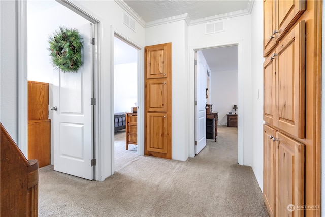 hall featuring light colored carpet and crown molding