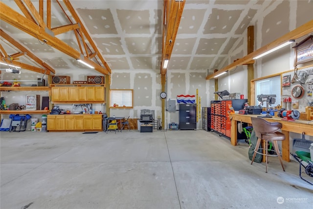 garage with a workshop area and a garage door opener