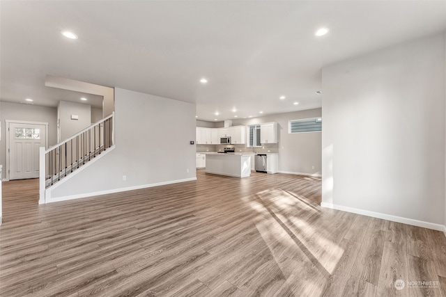 unfurnished living room with light wood-type flooring