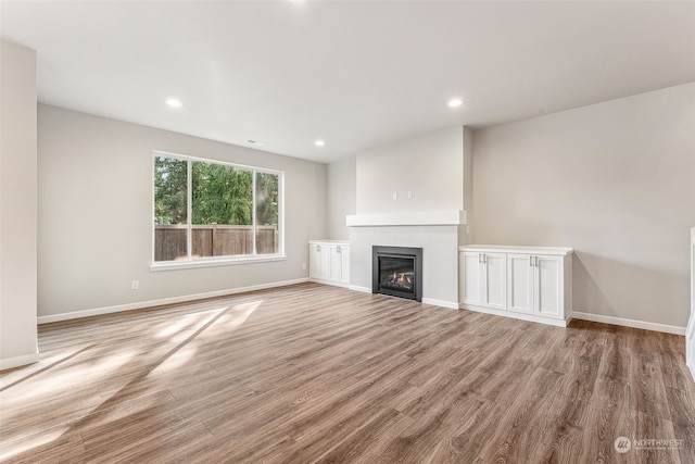 unfurnished living room featuring light hardwood / wood-style floors