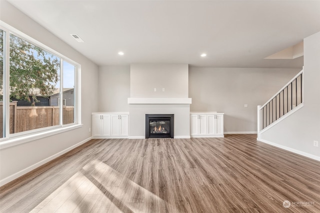 unfurnished living room with light hardwood / wood-style floors