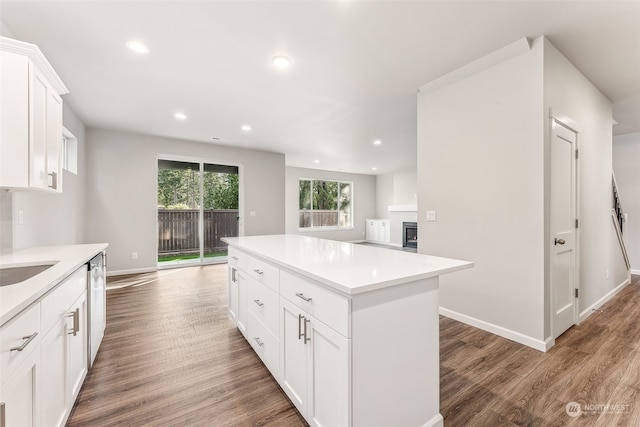 kitchen featuring a kitchen island, dishwasher, dark hardwood / wood-style floors, and white cabinets