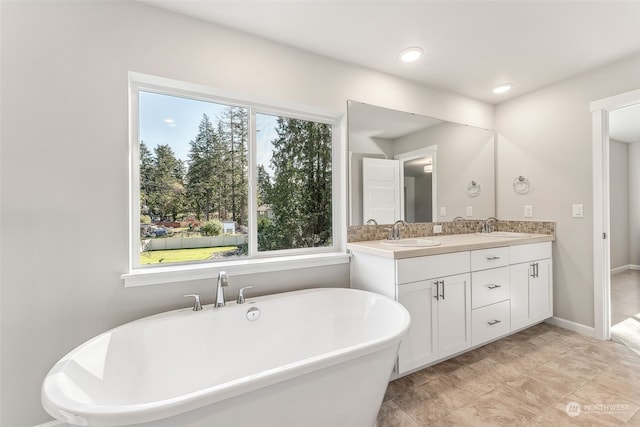 bathroom with a bathtub and vanity