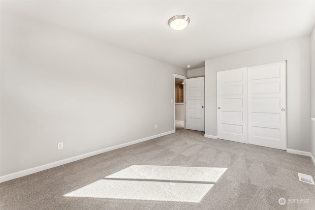 unfurnished bedroom featuring a closet and carpet