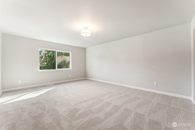 spare room with light carpet