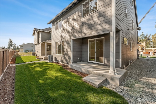 back of house with cooling unit, a lawn, and a patio area