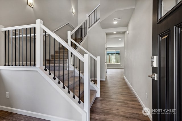 foyer entrance with recessed lighting, visible vents, baseboards, and wood finished floors