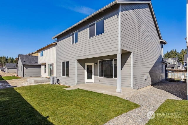 rear view of house featuring a patio area, a yard, and central AC unit