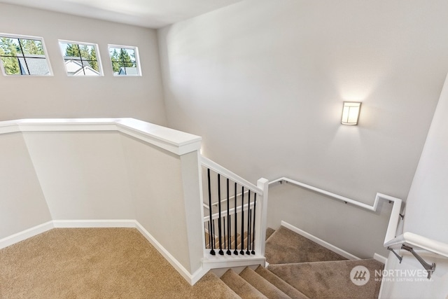 staircase with carpet floors and baseboards