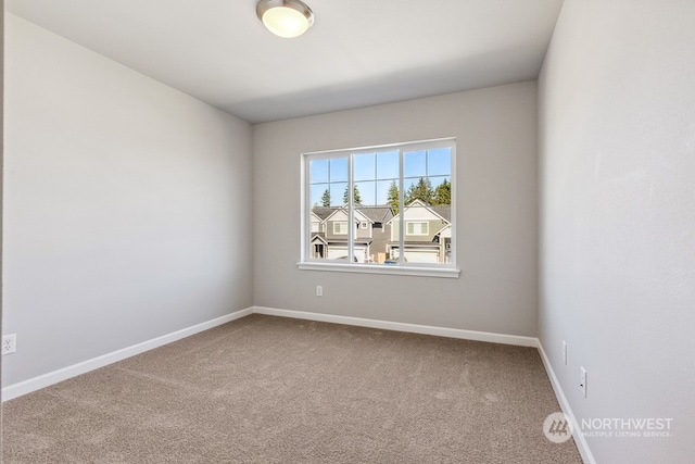 unfurnished room featuring carpet flooring and baseboards