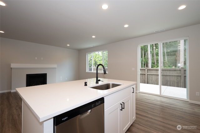 kitchen with white cabinets, dishwasher, a kitchen island with sink, dark hardwood / wood-style floors, and sink