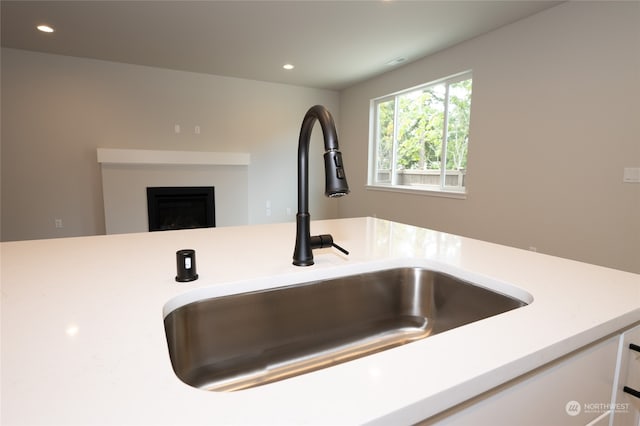 interior details featuring white cabinets and sink