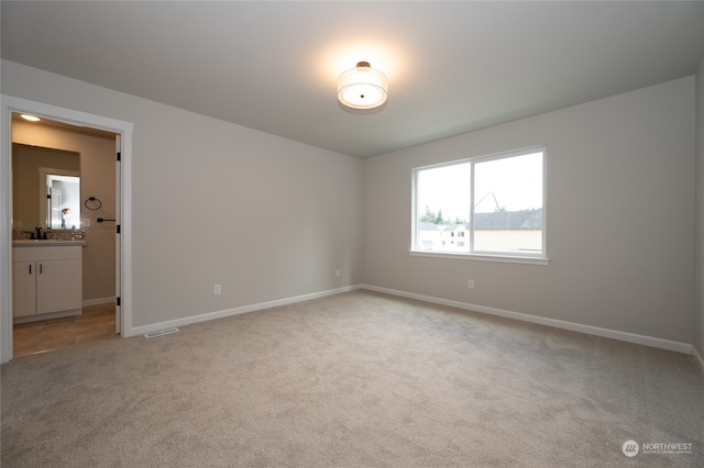 unfurnished room with light colored carpet