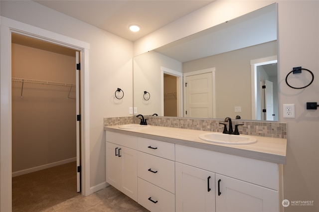 bathroom with tile patterned flooring, backsplash, and vanity