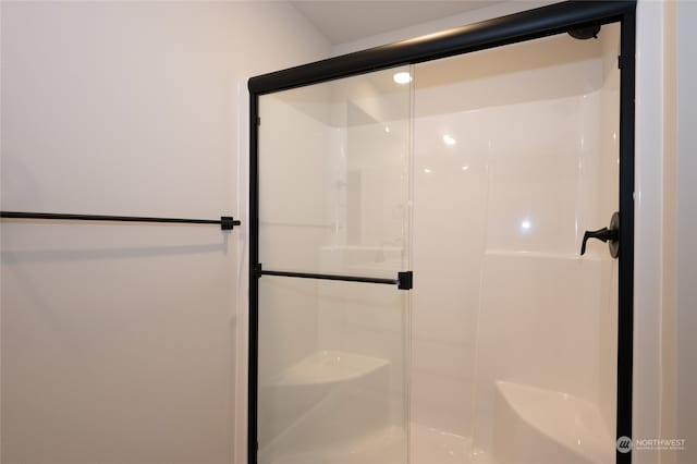 bathroom with a shower with shower door