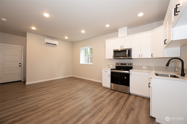 kitchen featuring white cabinets, appliances with stainless steel finishes, dark wood-type flooring, and sink