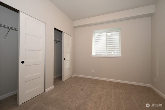 unfurnished bedroom with carpet and a closet