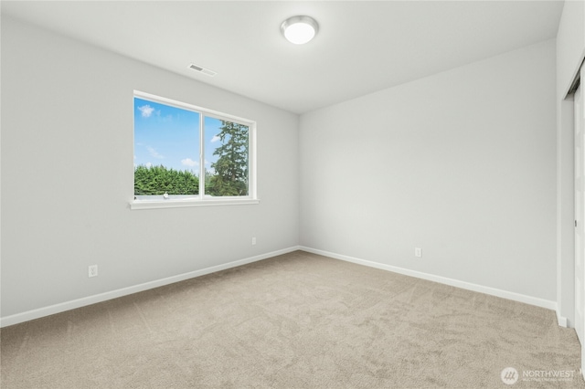 unfurnished bedroom featuring baseboards, visible vents, and carpet