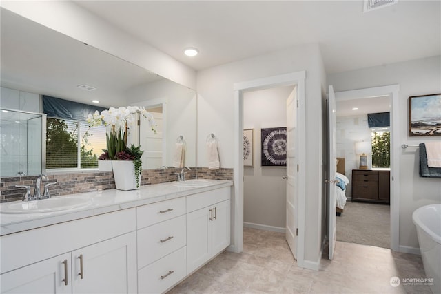 bathroom with a shower with shower door, backsplash, and vanity