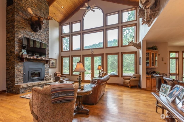 living room with wooden ceiling, a fireplace, high vaulted ceiling, and light hardwood / wood-style floors