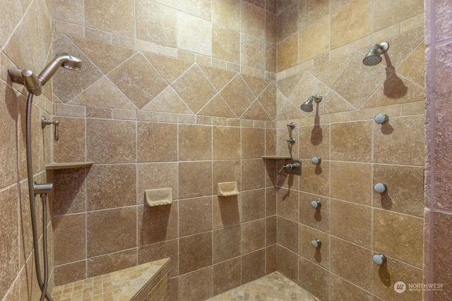 bathroom with a tile shower