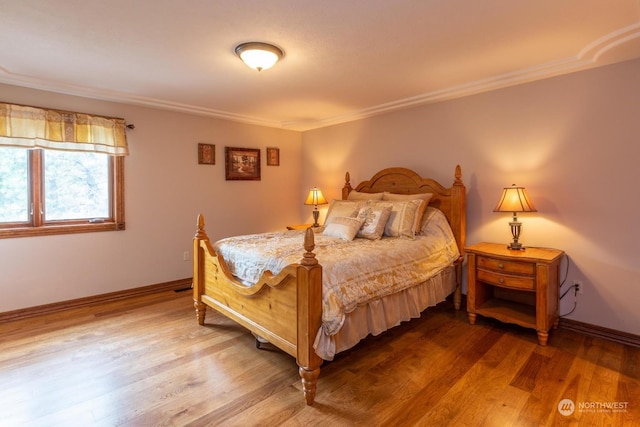 bedroom featuring crown molding and wood-type flooring