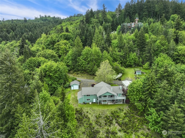 birds eye view of property with a wooded view