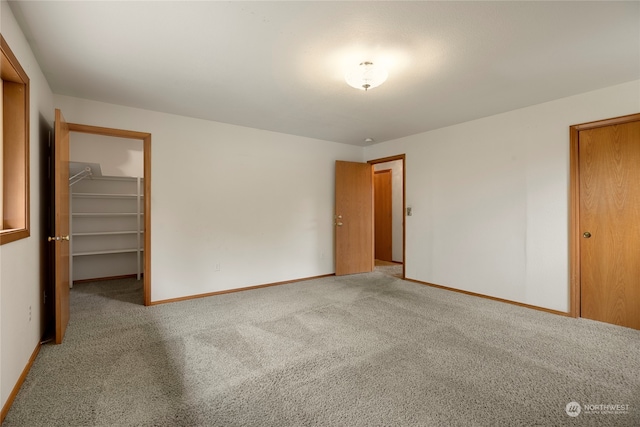 carpeted spare room with baseboards