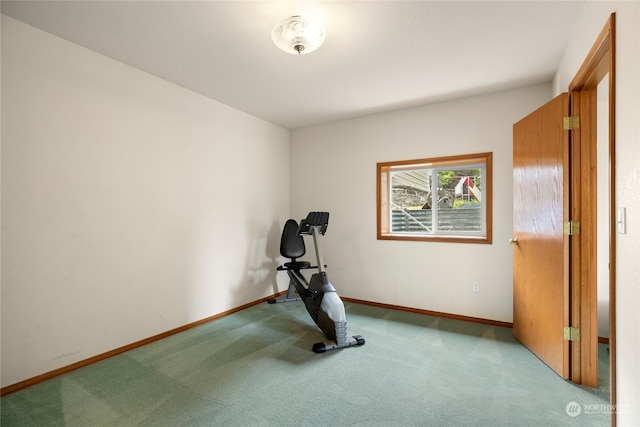 exercise room with carpet flooring and baseboards