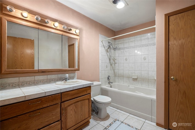 full bath featuring tile patterned flooring, bathtub / shower combination, vanity, and toilet