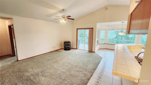 living room with light tile patterned floors, ceiling fan, high vaulted ceiling, light colored carpet, and baseboards