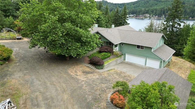 aerial view featuring a water view and a view of trees