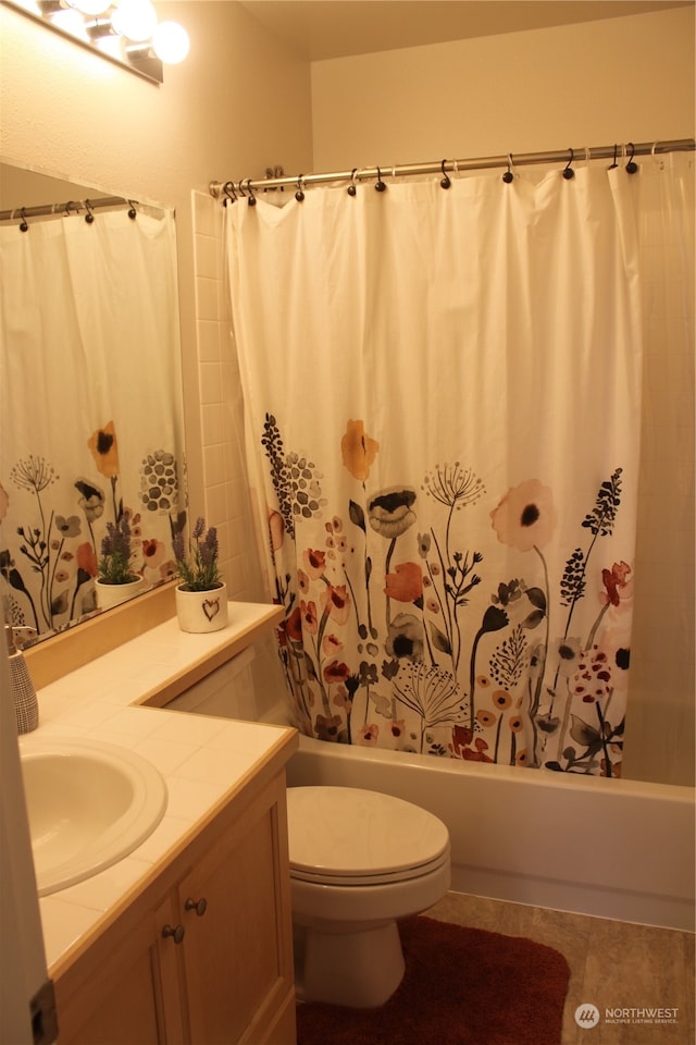 full bathroom with tile floors, toilet, shower / bath combo with shower curtain, and large vanity