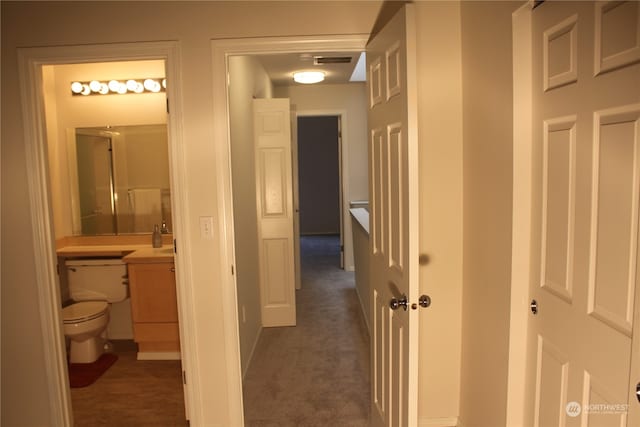 hallway with dark carpet